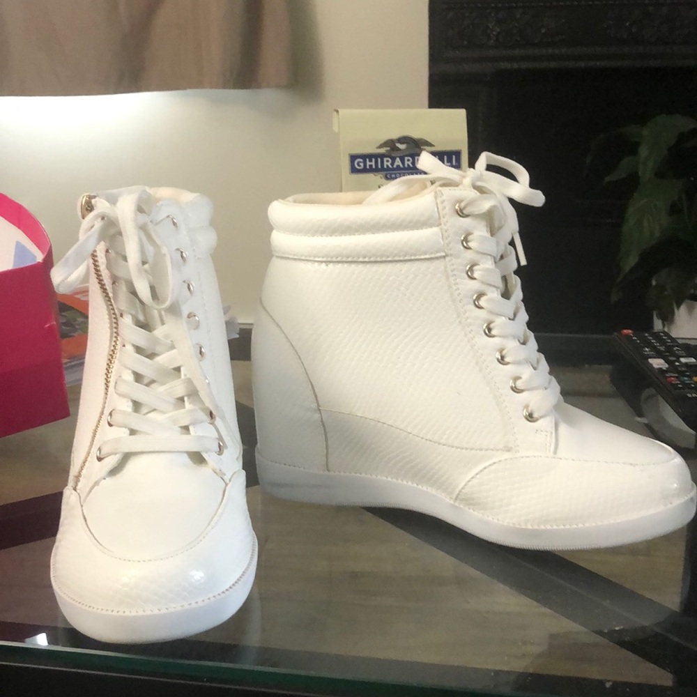 White platform wedge sneakers.